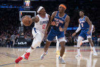 Los Angeles Clippers guard Eric Bledsoe (12) drives against New York Knicks guard Immanuel Quickley (5) during the second half of an NBA basketball game, Sunday, Jan. 23, 2022, in New York. (AP Photo/John Minchillo)