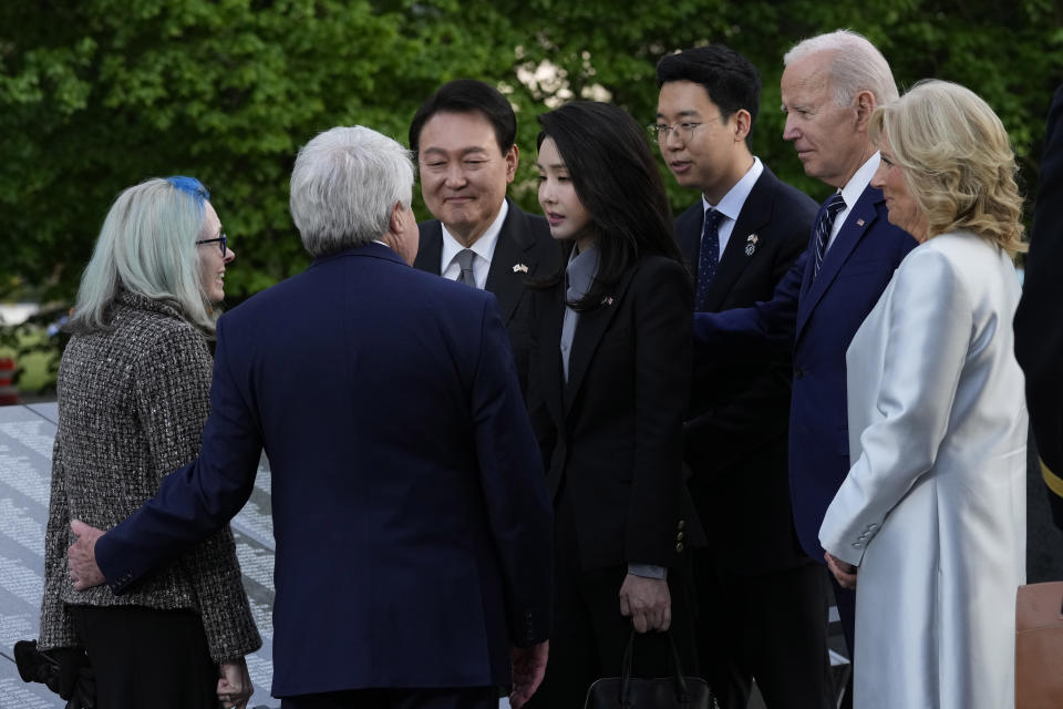 President Joe Biden, first lady Jill Biden, South Korea's President Yoon Suk Yeol and his wife Kim Keon Hee talk with Judy Wade, the niece of Medal of Honor recipient Cpl. Luther Story, and her husband Joseph Wade, as they visit the Korean War Veterans Memorial in Washington, Tuesday, April 25, 2023. (AP Photo/Susan Walsh)