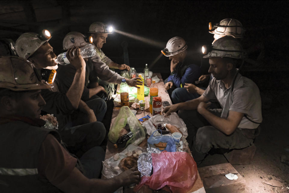 Bosnian coal miners break fast in the underground at a mine in Zenica, Bosnia, Thursday, April 29, 2021. Inside mine shafts, one can't see sunset, but miners consult their watches and smartphones for the right time to sit down, unwrap their food and break their daily fast together. (AP Photo/Kemal Softic)