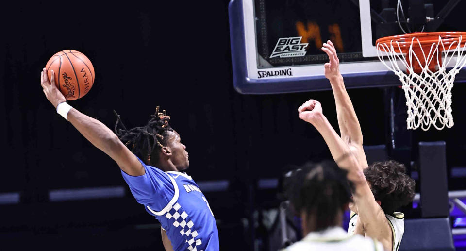 Hamilton forward Andrea Holden (2) dunks over Sycamore center Raleigh Burgess during their district final win Sunday, March 10, 2024.