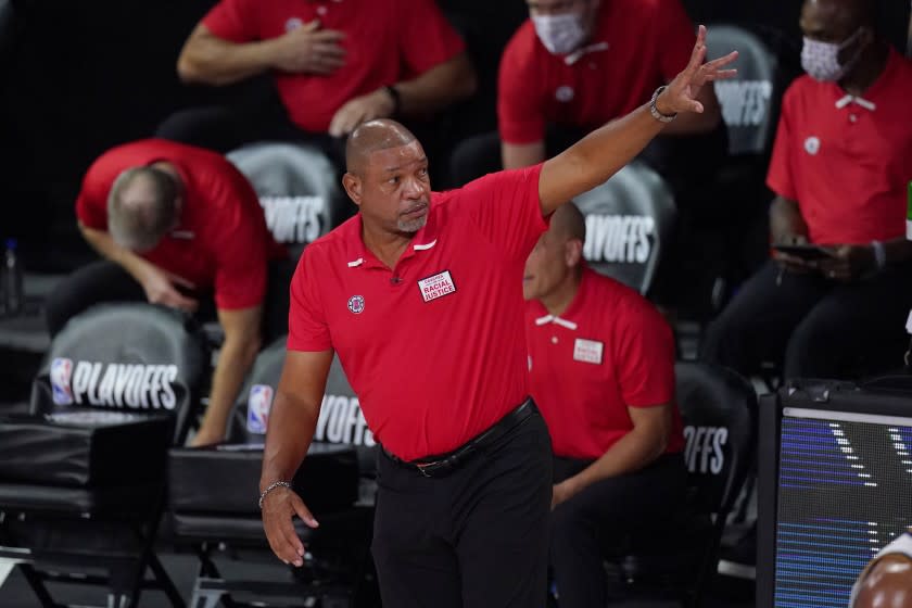 Los Angeles Clippers head coach Doc Rivers waves to the Denver Nuggets after the Clippers defeated the Nuggets in an NBA conference semifinal playoff basketball game Thursday, Sept 3, 2020, in Lake Buena Vista Fla. (AP Photo/Mark J. Terrill)