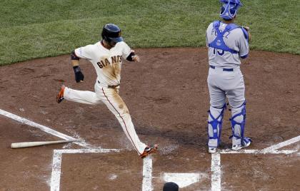 Gregor Blanco scores in front of Kansas City Royals catcher Salvador Perez. (AP Photo)