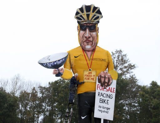 Artist Frank Shepherd of the Edenbridge Bonfire Society puts the finishing touches to a giant effigy of Lance Armstrong in Edenbridge, Kent. The disgraced US cyclist will suffer a fresh humiliation this weekend when the town burns the 30ft guy