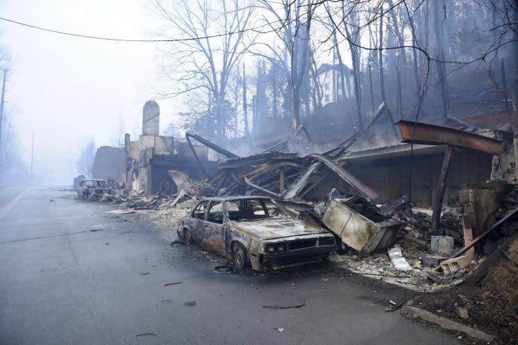 A structure and vehicle are damaged from the wildfires around Gatlinburg, Tenn., on Tuesday, Nov. 29, 2016. (Photo: Michael Patrick/Knoxville News Sentinel via AP)