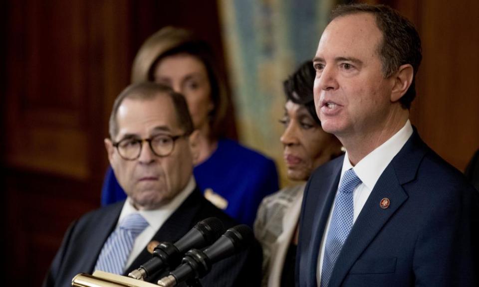 Adam Schiff, Chairman of the House Intelligence Committee, right, speaks during a news conference to unveil articles of impeachment against President Donald Trump.