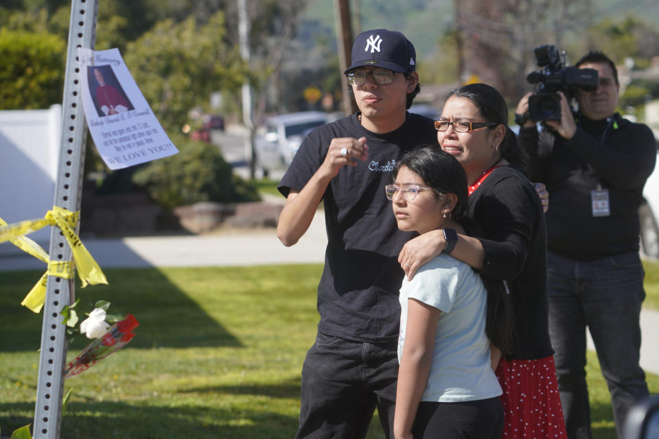 Gabriela Gil and her children pay their respects to Bishop David O'Connell at the corner of his home in Hacienda Heights, Calif., Sunday, Feb. 19, 2023. O'Connell was shot and killed Saturday just blocks from a church, a slaying of a longtime priest hailed as a “peacemaker” that's stunned the Los Angeles religious community, authorities said. Detectives are investigating the death as a homicide, according to the Los Angeles County Sheriff's Department. (AP Photo/Damian Dovarganes, File)