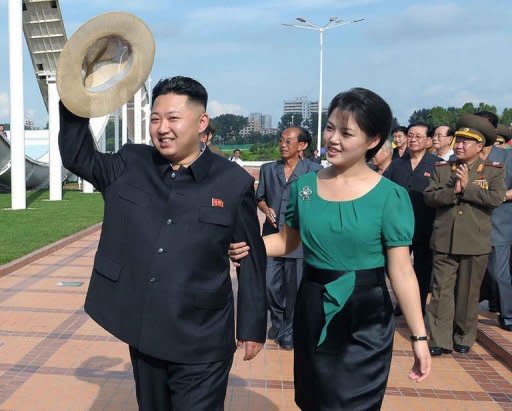 North Korean leader Kim Jong-Un (L), accompanied by his wife Ri Sol-Ju (R), visit the Rungna People's Pleasure Ground in Pyongyang. While Kim Jong-Il's wives were never pictured at official functions, "the regime is now facing a different situation, and the move is part of work to make Kim Jong-Un appear old and wise enough to rule", said Seoul-based online newspaper the Daily NK