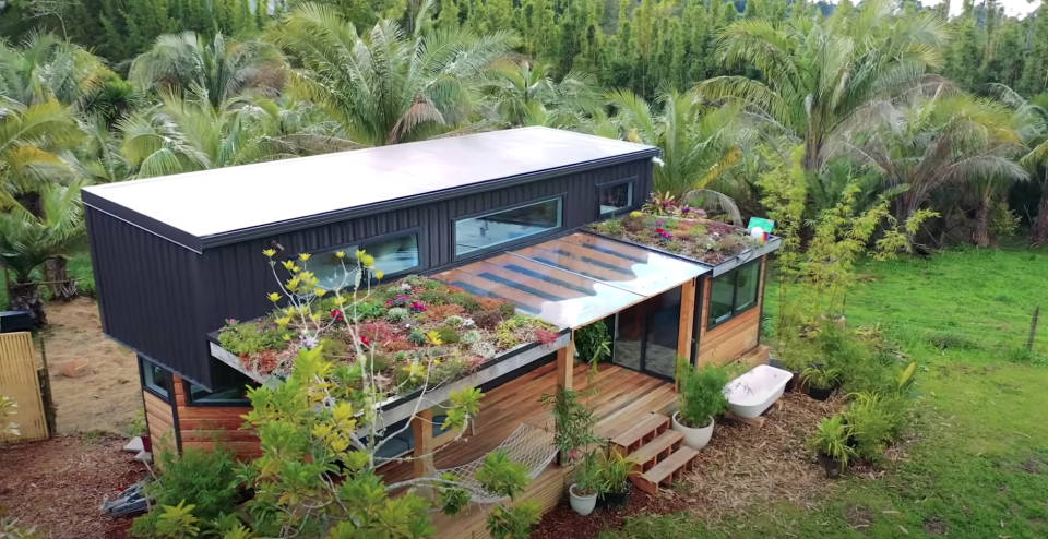 A beautiful home in a tropical paradise with a lush garden on the roof