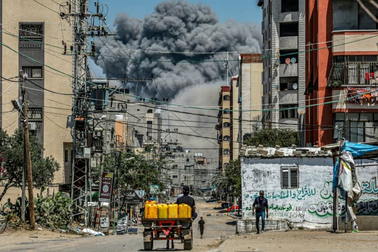 Una gigantesca humareda aparecen al fondo de una calle de Nuseirat tras una explosión, el 17 de abril de 2024 en el centro de la Franja de Gaza (-)