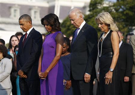 U.S. President Barack Obama (L to R), first lady Michelle Obama, Vice President Joe Biden and Jill Biden pause for a moment of silence on the 12th anniversary of the attacks of September 11, 2001, on the South Lawn of the White House in Washington, September 11, 2013. REUTERS/Jason Reed