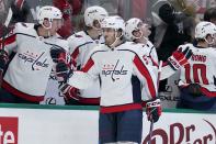 Washington Capitals defenseman Trevor van Riemsdyk (57) celebrates with the bench after scoring against the Dallas Stars in the first period of an NHL hockey game in Dallas, Friday, Jan. 28, 2022. (AP Photo/Tony Gutierrez)