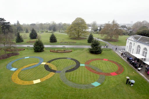 Giant Olympic rings made up of over 20,000 flowers are unveiled at Kew Gardens in London on April 18, 2012 to mark 100 days until the London 2012 Olympic Games. London Olympic organisers stressed the importance of creating a legacy from the Games on April 18 as they started the 100-day countdown by unveiling the event's motto: "Inspire a generation". AFP PHOTO / JUSTIN TALLIS