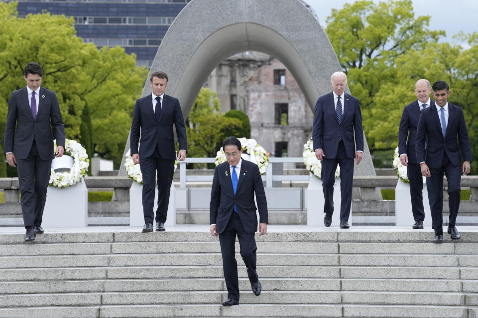 Members of the G7, from left, Canada's Prime Minister Justin Trudeau, French President Emmanuel Macron, Japan's Prime Minister Fumio Kishida, President Joe Biden, German Chancellor Olaf Scholz, and British Prime Minister Rishi Sunak, walk down steps after placing a wreath at the Hiroshima Peace Memorial Park in Hiroshima, Japan, Friday, May 19, 2023, during the G7 Summit. (AP Photo/Susan Walsh, POOL)