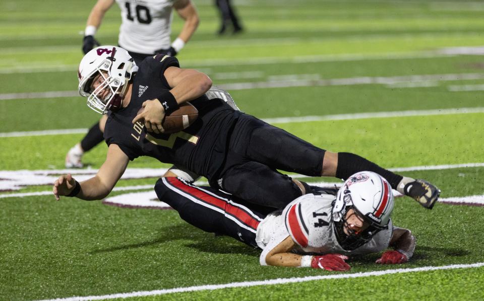 McDonald County’s Jack Parnell trips up Logan-Rogersville QB Thessen Prenger on September 9, 2022.