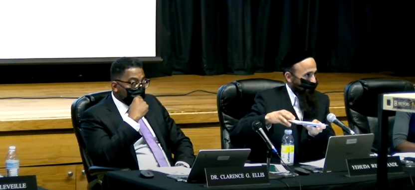 East Ramapo schools Superintendent Clarence Ellis, left, and school board President Yehuda Weissmandl listen to public comment during the Oct. 5, 2021 school board meeting at Spring Valley High School.