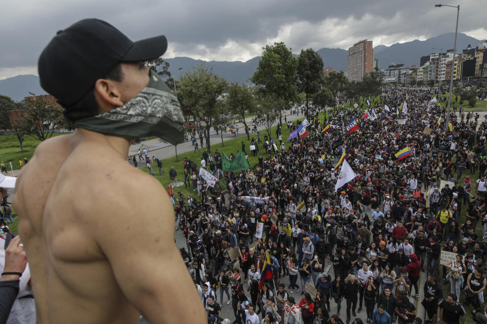 Anti-government protesters march in Bogota, Colombia, Thursday, Nov. 21, 2019. Colombia's main union groups and student activists called for a strike to protest the economic policies of Colombian President Ivan Duque government and a long list of grievances. (AP Photo/Ivan Valencia)