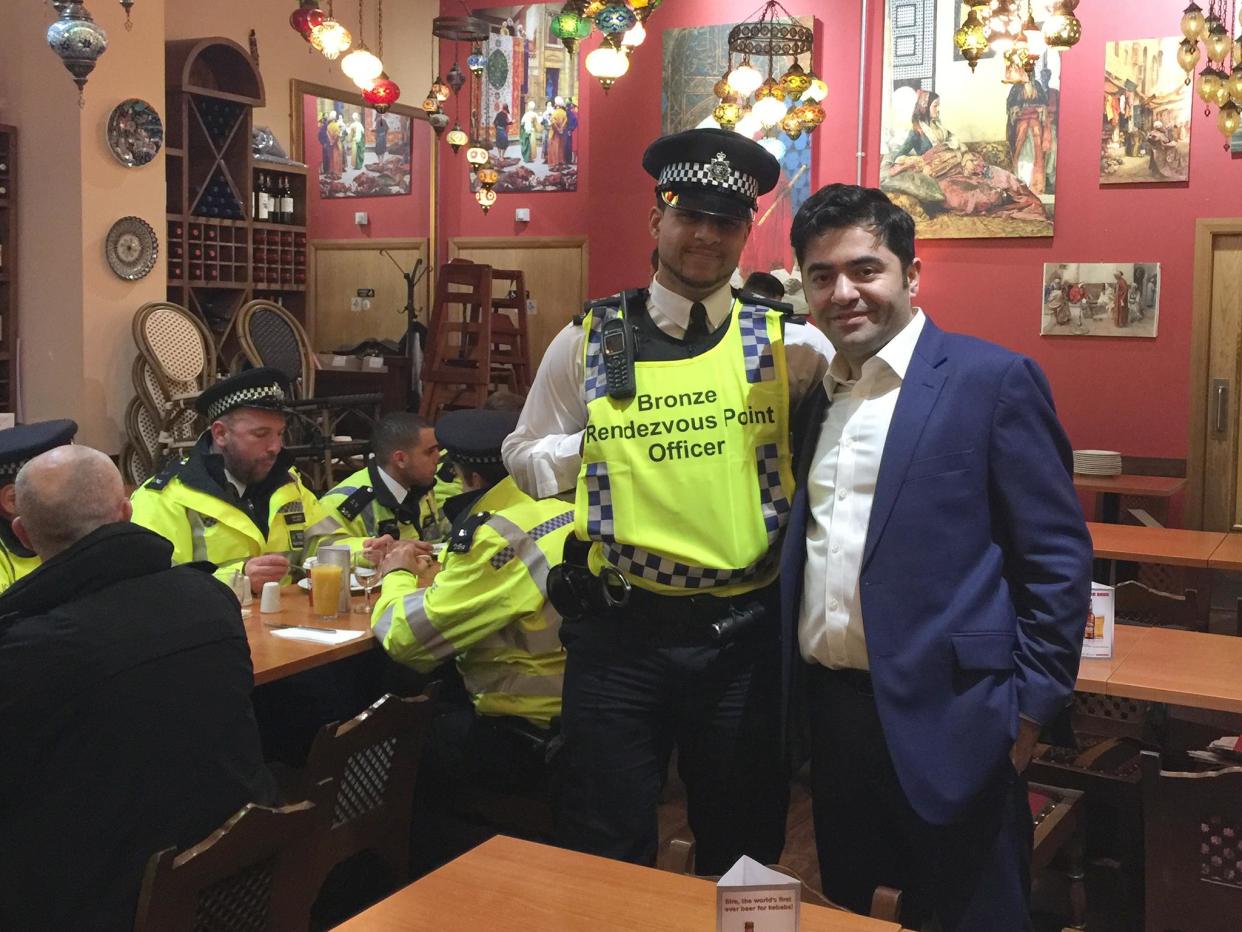 Ibrahim Dogus with police officers in Troia restaurant