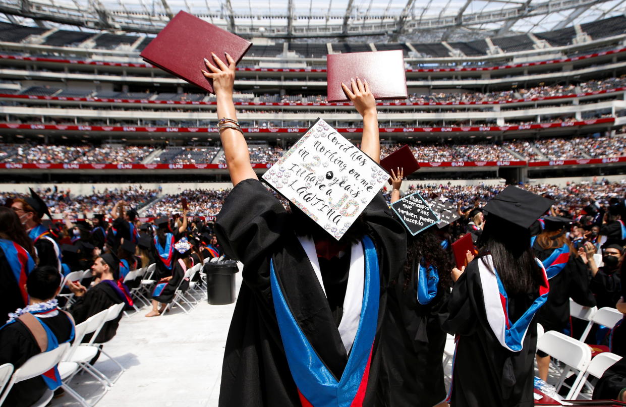 Graduates cheer during Loyola Marymount University's 109th commencement for graduating classes of 2020 and 2021 at SoFi Stadium in Inglewood, California, U.S., July 31, 2021.  REUTERS/Mario Anzuoni