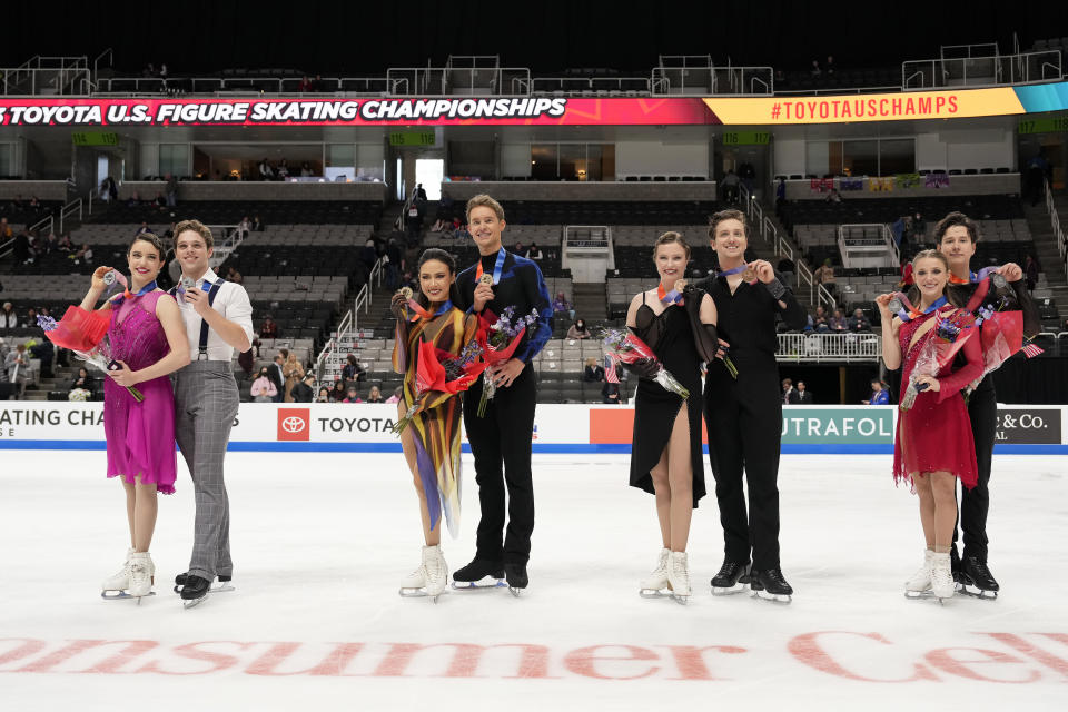 Caroline Green, Michael Parsons, Madison Chock, Evan Bates, Christina Carreira, Anthony Ponomarenko, Emilea Zingas and Vadym Kolesnik, from left, hold up their medals after the free dance at the U.S. figure skating championships in San Jose, Calif., Saturday, Jan. 28, 2023. Chock and Bates finished first, Green and Parsons finished second, Carreira and Ponomarenko finished third, and Zingas and Kolesnik finished fourth in the event. (AP Photo/Tony Avelar)