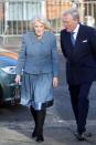 <p>Camilla chose a soft gray-blue skirt suit for a visit to a community center.</p>