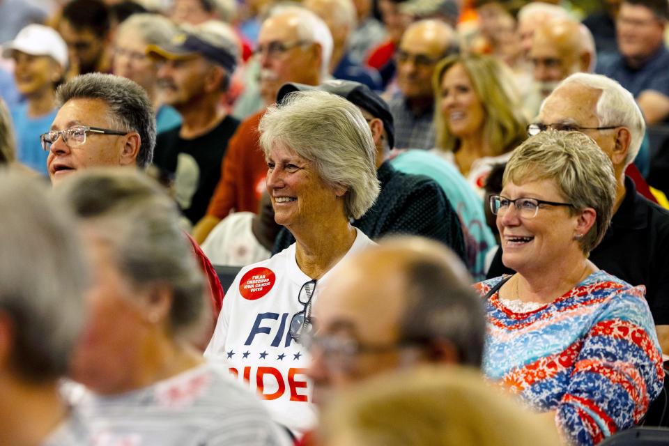 Potential caucus goers listen as Republican presidential candidates speak during the Ashley's BBQ Bash fundraiser, Sunday, Aug. 6, 2023, at Hawkeye Downs in Cedar Rapids, Iowa.