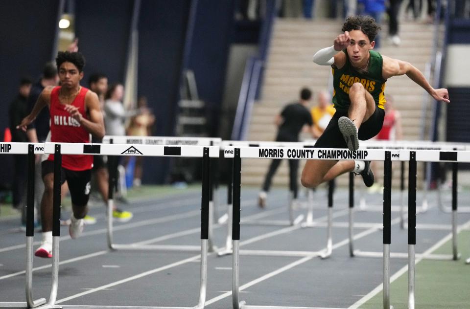 Justice Truesdale of Morris Hills as Elijah Bastos of Morris Knolls leads his team in the shuttle relay  at the Morris County Relays held at Drew University in Madison, NJ on January 3, 2023.