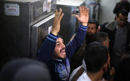 A Palestinian relative of Ibrahim Mansour, 26, who was killed by Israeli soldiers, reacts inside a hospital morgue in Gaza City February 13, 2014. REUTERS/Suhaib Salem