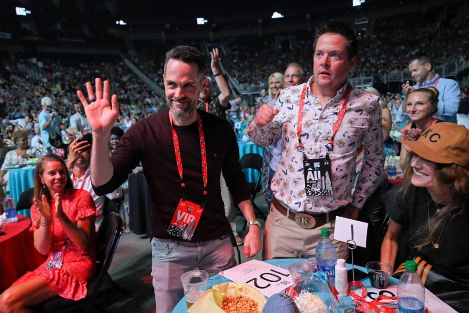 The Big Slick crowd applauded after Scott Gorran, left, of Indiana placed the winning $50,000 bid to appear on stage at next spring&#x002019;s NFL Draft in Kansas City. He and his wife, Ann Brady, far right, also bid $100,000 to fly to London and play extras on &#x00201c;Ted Lasso.&#x00201d;