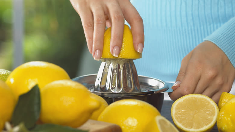 Person juicing a lemon