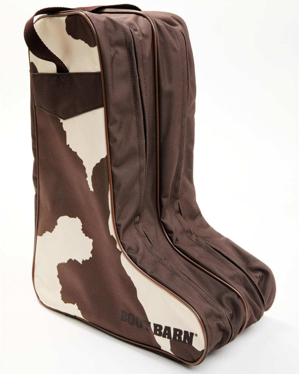 <p><a href="https://www.bootbarn.com/boot-barn-cow-print-boot-bag/2000390569.html?sku=69403400005&colorCode=200&glCountry=US&glCurrency=USD&gad_source=1&gclid=CjwKCAjwt-OwBhBnEiwAgwzrUoUgQW8xewxeecG0x_v0DvJxJyrdcYQ1rGU2SH3yj4QHtKj1ybVsfhoCEe8QAvD_BwE" rel="nofollow noopener" target="_blank" data-ylk="slk:Shop Now;elm:context_link;itc:0;sec:content-canvas" class="link ">Shop Now</a></p><p>Boot Barn Cow Print Boot Bag</p><p>bootbarn.com</p><p>$34.95</p><span class="copyright">Boot Barn</span>