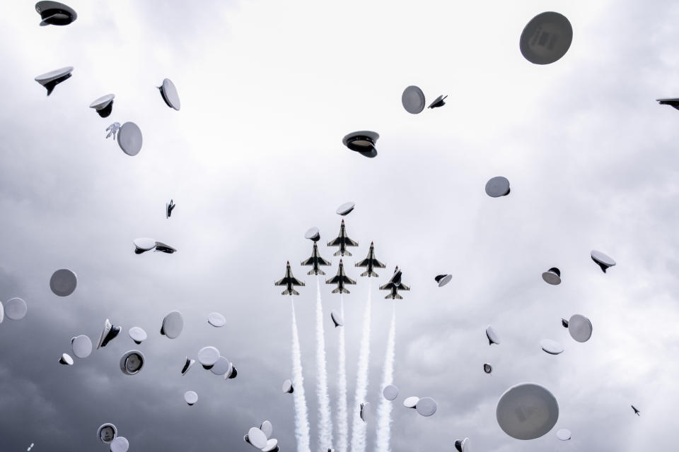Jets fly overhead as graduates toss their hats into the air at the conclusion of the 2023 United States Air Force Academy Graduation Ceremony at Falcon Stadium on June 1, 2023, in Colorado Springs, Colo. (AP Photo/Andrew Harnik)