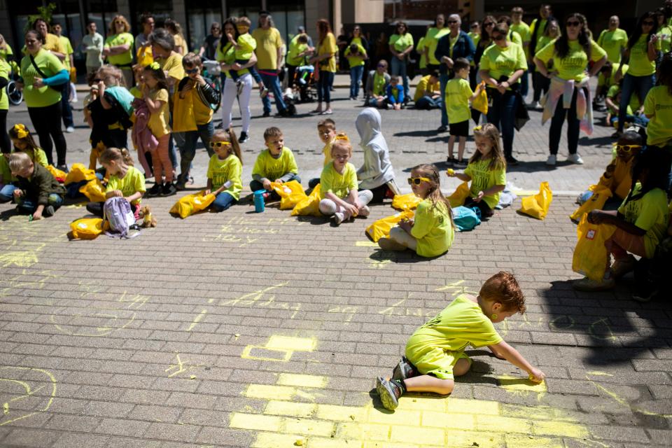 Local area school children, volunteers and students business owners celebrate Yellow Day on May 5, 2023, in downtown Chillicothe, Ohio.