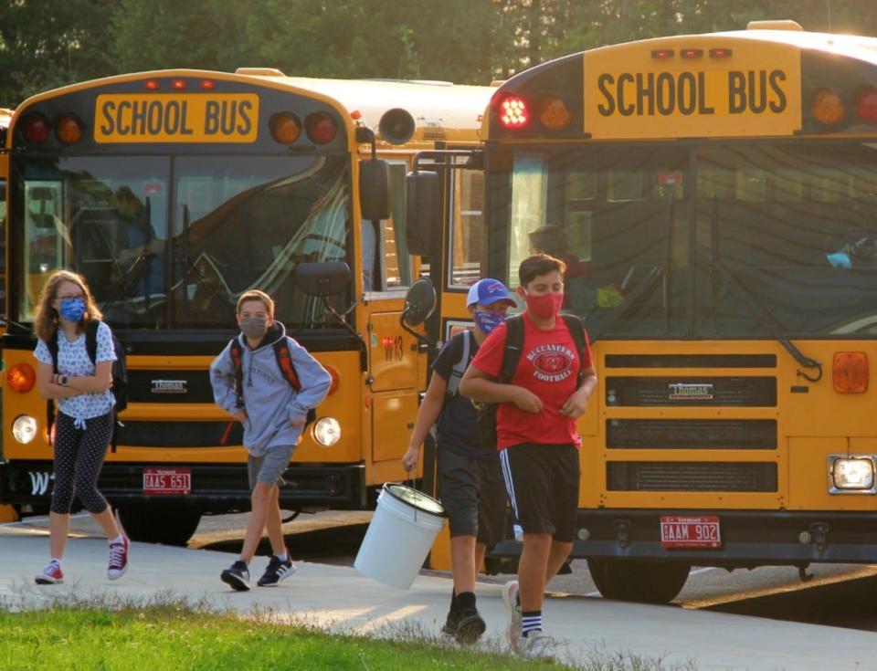 Williston Central School students exit the bus on the first day of school on September 8, 2020.