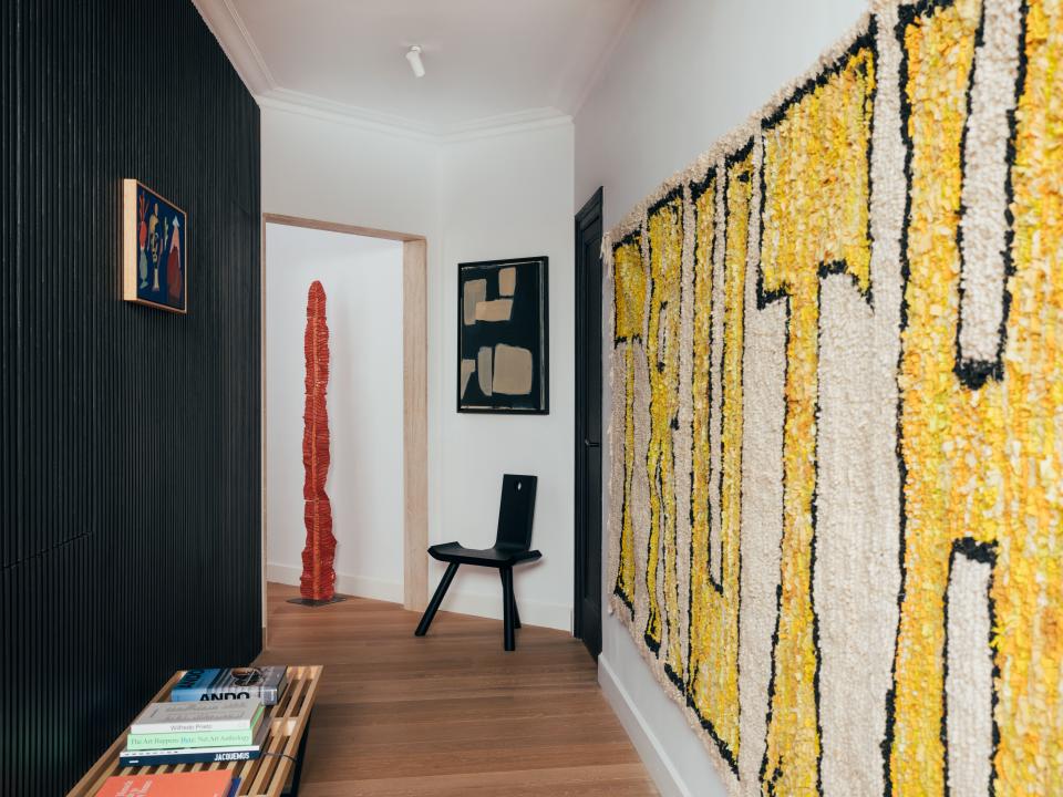 A hallway corridor becomes a gallery walk. Josep Maynou’s “Truth” tapestry makes a bold statement. In the distance is a sculpture by Giovanni Vetere, chair by Adolfo Abejon and a painting by Yvonne Robert.