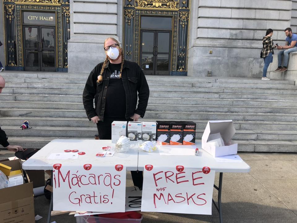 A&nbsp;member of the Democratic Socialists of America distributes masks outside City Hall in San Francisco. (Photo: DSASF)