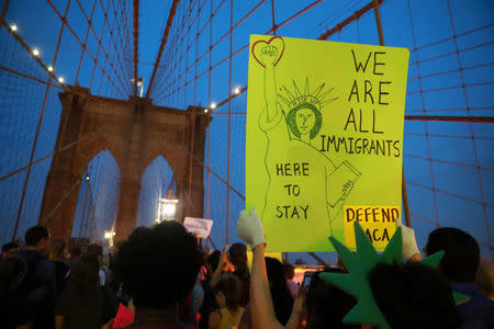 FILE PHOTO: People march across the Brooklyn Bridge to protest the planned dissolution of DACA in Manhattan, New York City, U.S. September 5, 2017. REUTERS/Stephen Yang