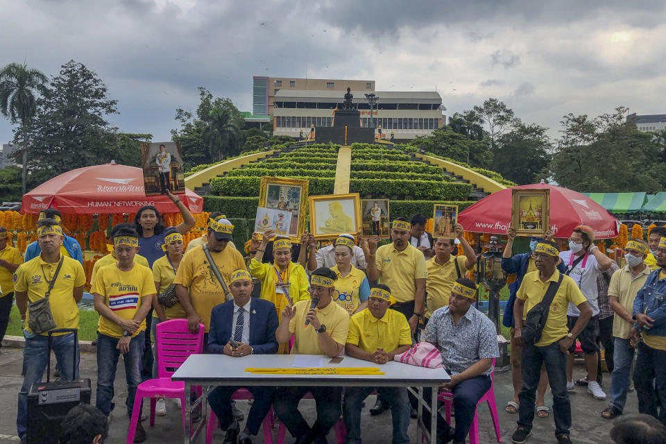 Supporters of monarchy display pictures of Thailand's King Maha Vajiralongkorn and Queen Suthida during a gathering to show their support at Ramkhamhaeng University in Bangkok, Thailand, Wednesday, Oct. 21, 2020. A small group of royalist gathered to show their loyalty to the monarchy and declare they will defend the institution from any attacks. Royalists this week stepped up their activities online and in the streets, in counterpoint to ongoing student-led protests whose demands include reform of the monarchy to have it to better conform with democratic norms. (AP Photo/ Peerayot Lakkananukul)