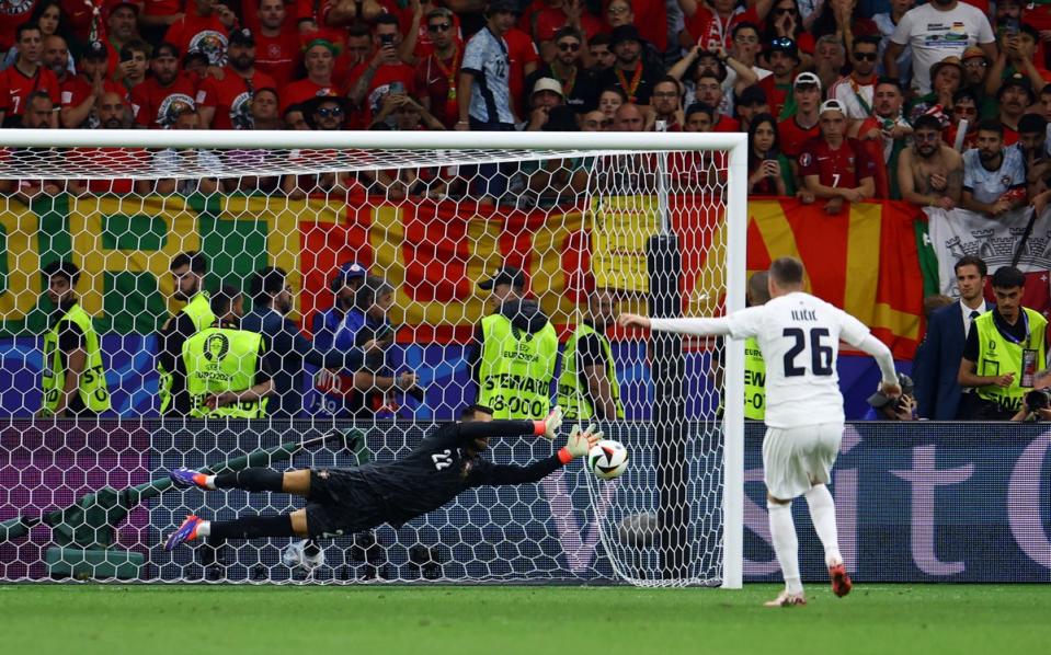 Diogo Costa saves a penalty from Slovenia’s Josip Ilicic (Reuters)