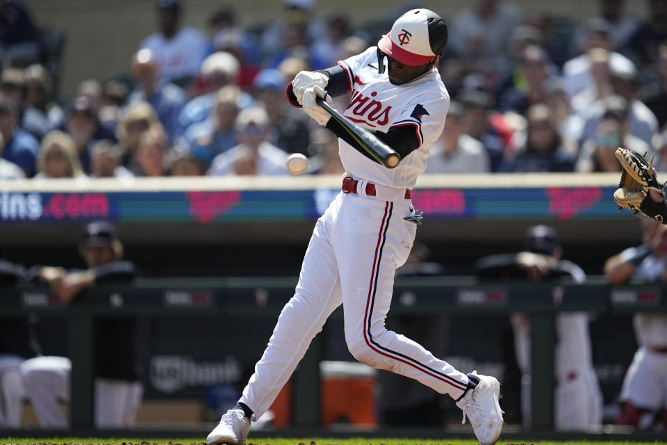 Minnesota Twins' Nick Gordon hits into a fielder's choice to score a run during the third inning of a baseball game against the Chicago White Sox, Monday, April 10, 2023, in Minneapolis. (AP Photo/Abbie Parr)