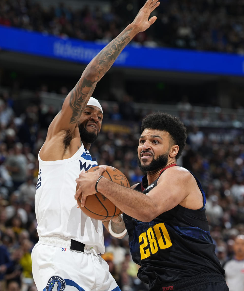 Denver Nuggets guard Jamal Murray, right, drives to the basket as Minnesota Timberwolves guard Nickeil Alexander-Walker, left, defends in the first half of Game 2 of an NBA basketball second-round playoff series Monday, May 6, 2024, in Denver. (AP Photo/David Zalubowski)