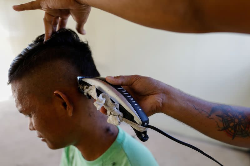 A drug rehab patient gets his hair cut at the Mega Drug Abuse Treatment and Rehabilitation Center, in Nueva Ecija province, north of Manila