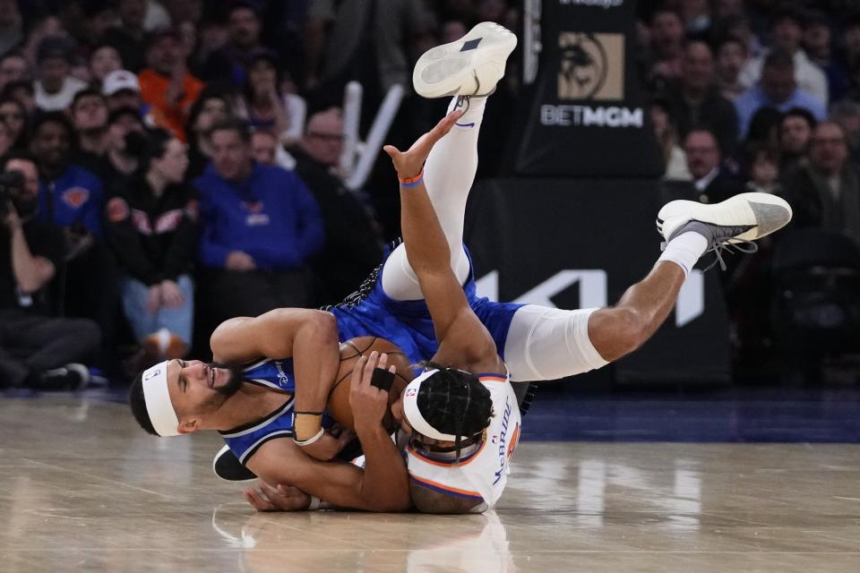 Orlando Magic's Jalen Suggs, left, fights for control of the ball with New York Knicks' Miles McBride, right, during the first half of an NBA basketball game Monday, Jan. 15, 2024, in New York. (AP Photo/Frank Franklin II)
