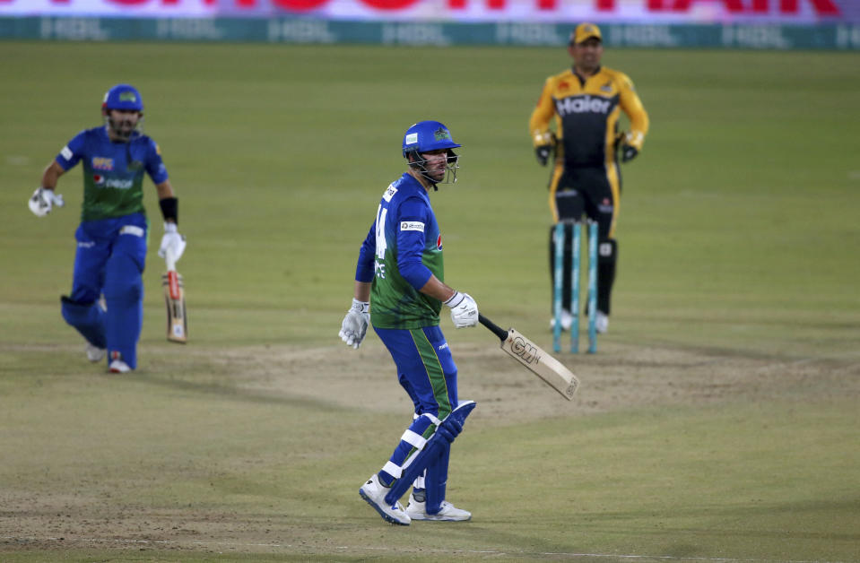 Multan Sultans' James Vince, center, follows the ball after playing a shot for boundary during a Pakistan Super League T20 cricket match between Multan Sultans and Peshawar Zalmi at the National Stadium, in Karachi, Pakistan, Tuesday, Feb. 23, 2021. (AP Photo/Fareed Khan),