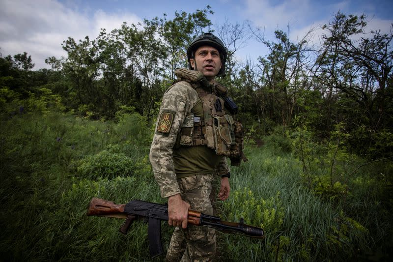 Ukrainian serviceman walks at a position near the frontline town of Bakhmut