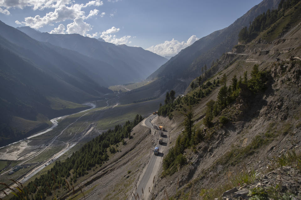Vehicles run through the Zojila Pass northeast of Srinagar, Indian controlled Kashmir, Monday, Sept. 27, 2021. High in a rocky Himalayan mountain range, hundreds of people are working on an ambitious project to drill tunnels and construct bridges to connect the Kashmir Valley with Ladakh, a cold-desert region isolated half the year because of massive snowfall. The $932 million project’s last tunnel, about 14 kilometers (9 miles) long, will bypass the challenging Zojila pass and connect Sonamarg with Ladakh. Officials say it will be India’s longest and highest tunnel at 11,500 feet (3,485 meters). (AP Photo/Dar Yasin)