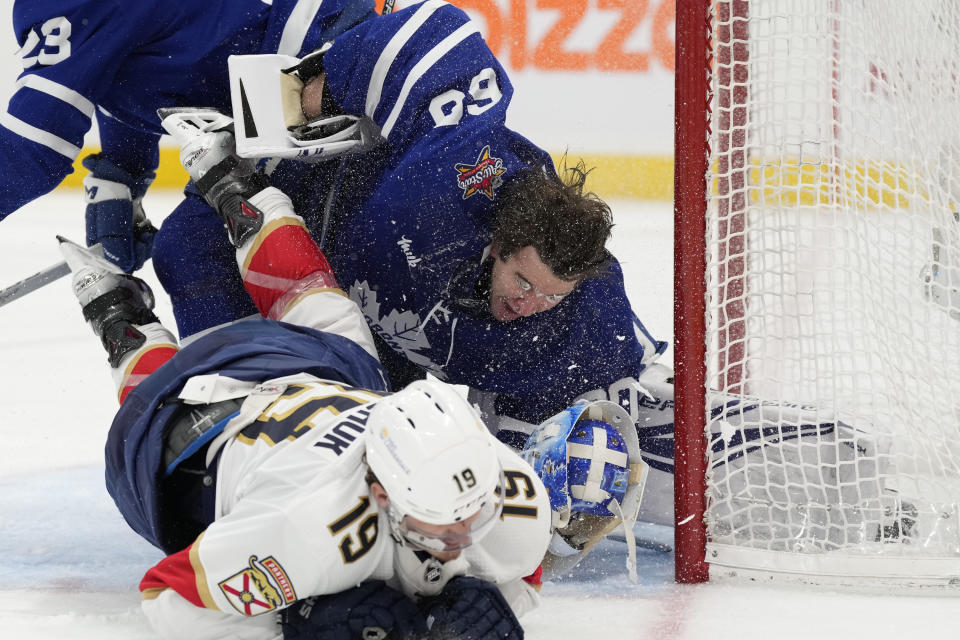 Florida Panthers left wing Matthew Tkachuk (19) crashes into Toronto Maple Leafs goaltender Joseph Woll as Leafs' Matthew Knies defends during the third period of an NHL hockey game in Toronto on Tuesday, Nov. 28, 2023. (Frank Gunn/The Canadian Press via AP)