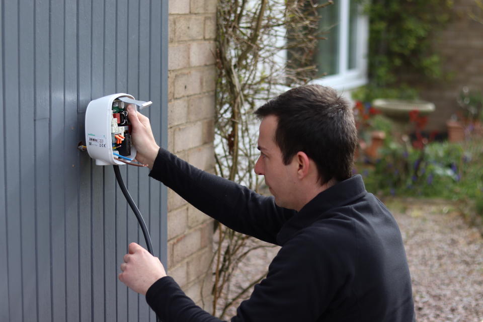 Engineer fitting home electric car charger