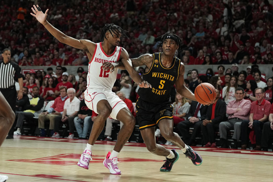 Houston guard Tramon Mark (12) defends against Wichita State guard Jaron Pierre Jr. (5) during the first half of an NCAA college basketball game Thursday, March 2, 2023, in Houston. (AP Photo/Kevin M. Cox)