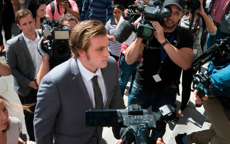 Henri van Breda arrives at the Western Cape High Court for the start of his trial for allegedly killing his two parents, brother, and wounding his sister, with an axe in Cape Town - Credit:  RODGER BOSCH/AFP