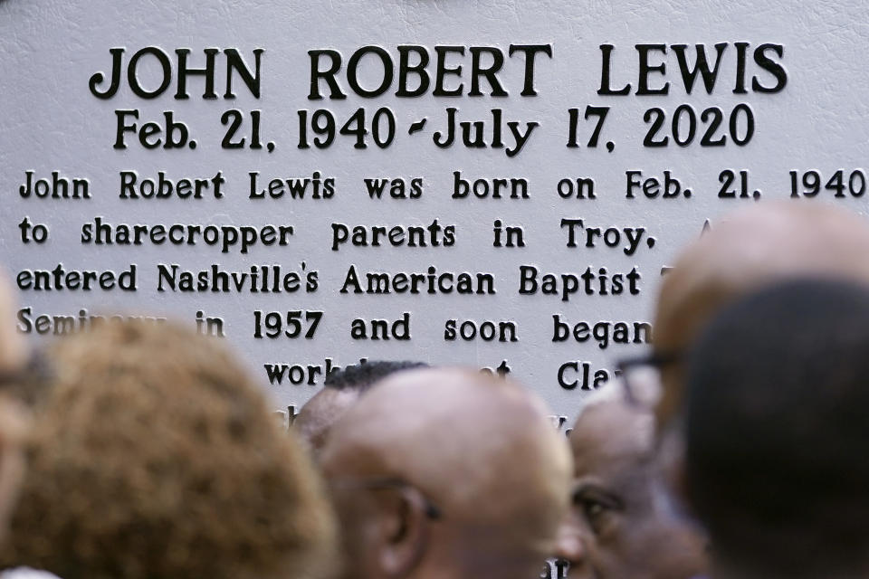 People look at a new historical marker remembering former Rep. John Lewis after it was unveiled Friday, July 16, 2021, in Nashville, Tenn. Earlier this year, Nashville's Metro Council renamed a large portion of Fifth Avenue to Rep. John Lewis Way. (AP Photo/Mark Humphrey)